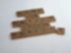Scrabble tiles spell DONE IS BETTER THAN PERFECT, with one T tile set off on a white background.