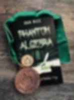 Dan Rice’s Phantom Algebra book with Readers’ Favorite award medals on a green ribbon, on a wood table.