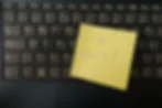 Yellow sticky note on a black laptop keyboard reads I Quit!
