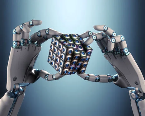 Robot hands holding a cube with binary numbers against a gradient blue background. The metallic hands and cube symbolize tech innovation.